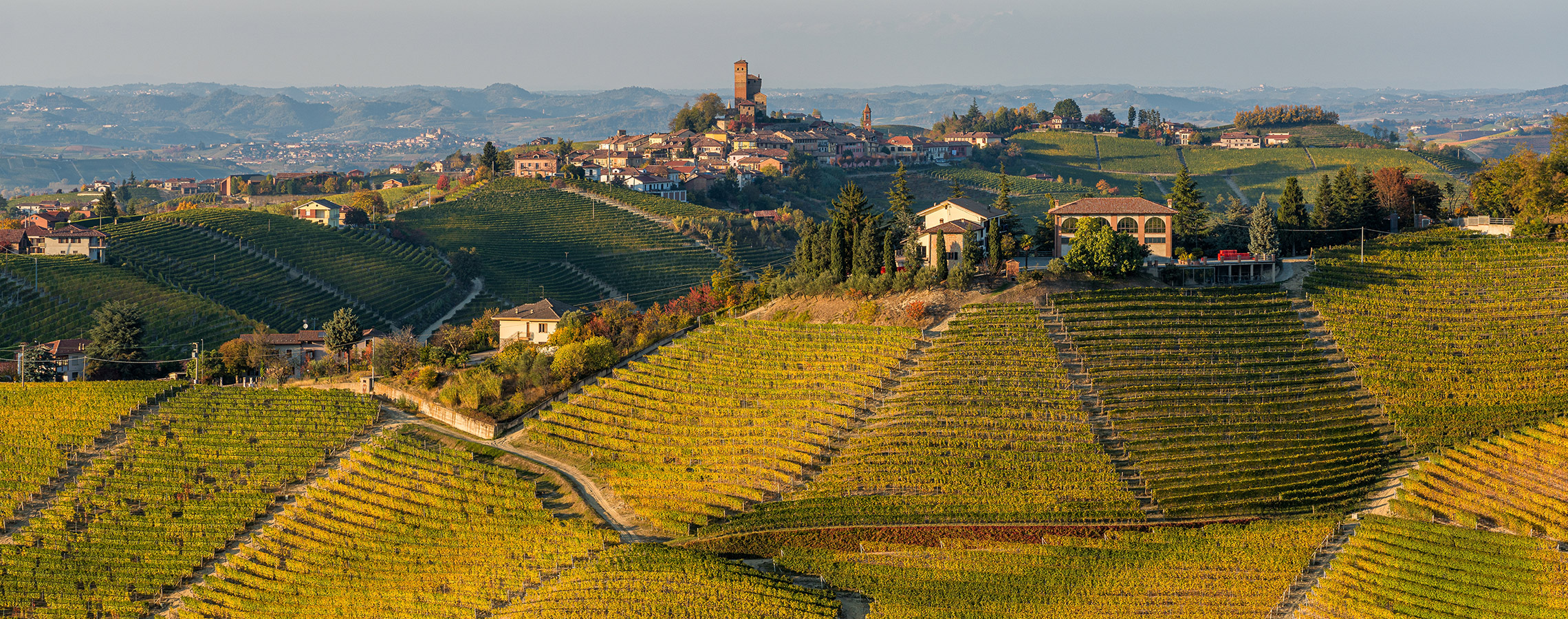 Beautiful hills and vineyards during fall season surrounding Serralunga d'Alba village