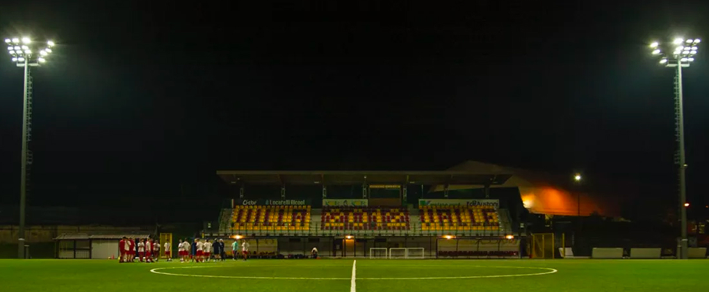 Un campo da gioco verde con la scritta Villa 2012 Valle sui sedili degli spalti. 